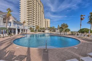 a large swimming pool with a tall building in the background at The Beach Club Resort and Spa IV in Gulf Highlands