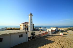 a lighthouse on a beach next to the ocean at Torcello in Bibione