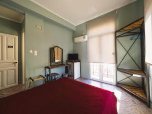 A bed or beds in a room at Filoxenia Hotel