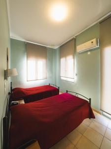 A bed or beds in a room at Filoxenia Hotel