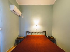 A bed or beds in a room at Filoxenia Hotel