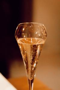 a glass of champagne sitting on top of a table at Trasti & Trine Boutique Hotel in Alta