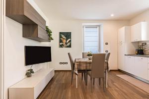 a kitchen and dining room with a table and chairs at Villa Vacanze Renetta in Tuenno +14 photos