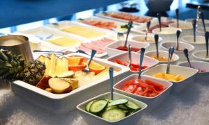 a table topped with trays of different types of food at Hotell Charlottenberg in Charlottenberg