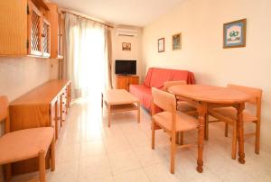 a living room with a table and a couch at APCOSTAS Los Iris - familiar in Playa de Gandia