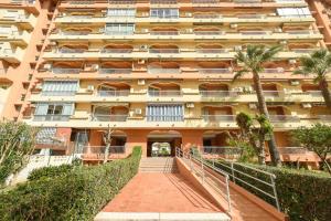 a large apartment building with a staircase in front of it at APCOSTAS Los Iris - familiar in Playa de Gandia