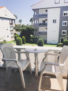 a white table and chairs on a balcony with a building at Conny's Hotel (Adult Only) +18 in Side