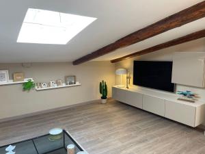 a living room with a flat screen tv on the wall at La Mansarda in Caserta