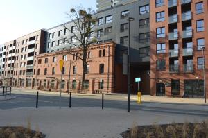 an empty street in front of a large brick building at Perla Gdańsk in Gdańsk