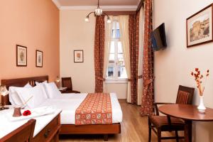 a hotel room with a bed and a table at Egli Hotel in Andros