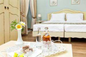 a tray of food on a table in a bedroom at Egli Hotel in Andros