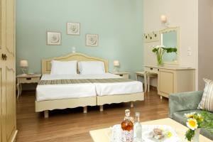 a bedroom with a bed and a living room at Egli Hotel in Andros