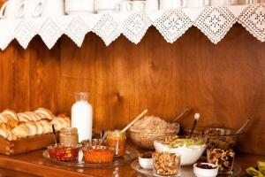 a table with bread and other food items on it at Egli Hotel in Andros
