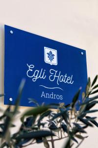a sign for an emu hotel and studios at Egli Hotel in Andros