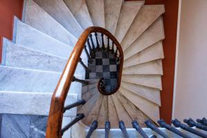 a spiral staircase in a building at Egli Hotel in Andros
