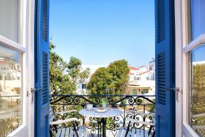 a view from the balcony of a apartment with a table at Egli Hotel in Andros