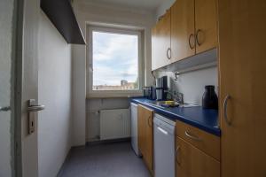 a kitchen with a blue counter top and a window at Private Rooms in Karlsruhe