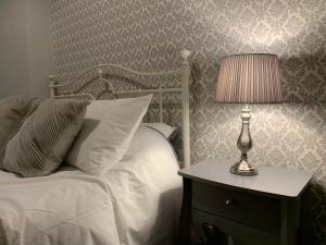 a bedroom with a bed and a lamp on a night stand at Sea View Apartment in Barmouth in Barmouth