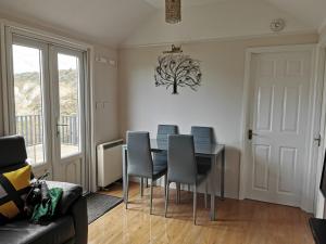 a dining room with a table and chairs at Anstey Cove in Bembridge