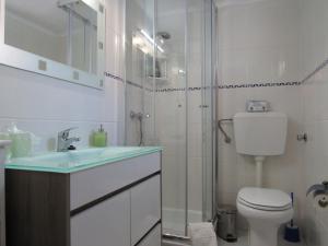 a bathroom with a shower and a toilet and a sink at Casa O Cantinho Algarvio in Odeceixe