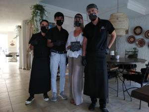 a group of people wearing masks posing for a picture at Conny's Hotel (Adult Only) +18 in Side +37 photos