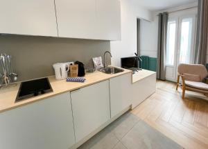a kitchen with a sink and a counter top at Be Mate Gran Vía Suites in Madrid