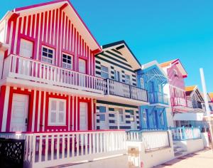 a row of colorful houses on a street at Aveiro, Ria e Fado in Aveiro