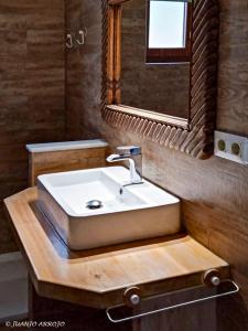 a bathroom with a white sink and a mirror at Villa for 4 with a private Pool & Garden in Bédar