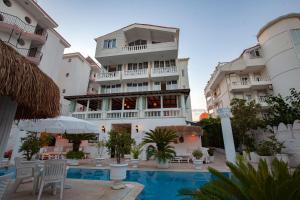 a hotel with a swimming pool in front of a building at Conny's Hotel (Adult Only) +18 in Side