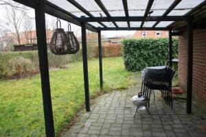 a patio with two chairs and a pergola at (014) Frodesgade 129 in Esbjerg