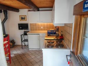 a small kitchen with white cabinets and a stove at Holiday Home Maria by Interhome in Brione