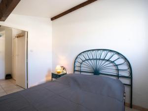 a bedroom with a bed and a white wall at Holiday Home Hacienda Beach II-4 by Interhome in Cap d'Agde