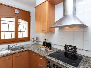 a kitchen with a sink and a stove top oven at Apartment Santa Isabel by Interhome in Llança