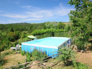 una piscina blu con sedia e ombrellone di Holiday Home La Vecchia Fattoria by Interhome a Santa Fiora