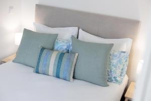 a pile of pillows sitting on top of a bed at Vilar Charming Studio - Palácio de Cristal in Porto