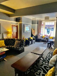 a living room with couches and a table at Hawthorn House in Blackpool