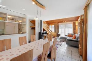 a kitchen and living room with a table and a couch at Apartments Kirchbühl in Grindelwald +27 photos