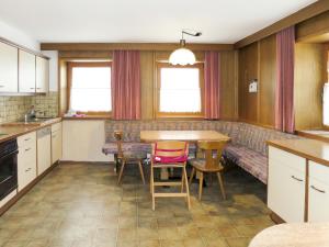 a kitchen with a table and chairs and a couch at Holiday Home Schrofner - MHO538 by Interhome in Ramsau im Zillertal