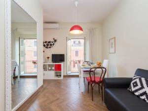 a living room with a table and a dining room at Apartment Regina's House - St Peter by Interhome in Rome