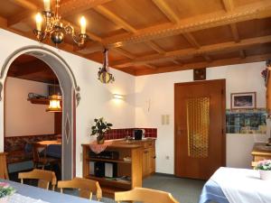 a dining room with a table and chairs and a chandelier at Holiday Home Palman - PFD160 by Interhome in Pfunds