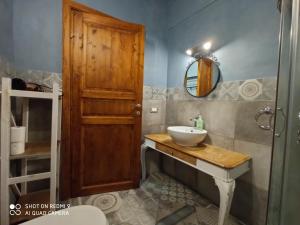 a bathroom with a sink and a wooden door at Veracini apartment in Florence