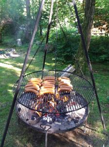 a bunch of hot dogs cooking on a grill at Pokoje Gościnne Perła in Brenna