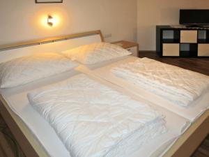 a large bed with white sheets and pillows on it at Holiday Home Mario - KPL340 by Interhome in Kappl