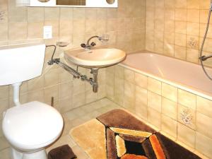 a bathroom with a sink and a toilet and a tub at Holiday Home Mario - KPL340 by Interhome in Kappl