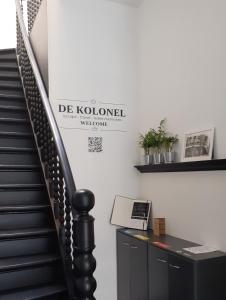 a staircase with a sign that reads de koloured at De Kolonel in Blankenberge