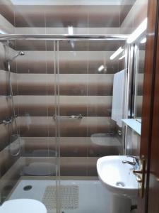 a bathroom with a shower and a toilet and a sink at Residencial das Trinas 2 in Guimarães