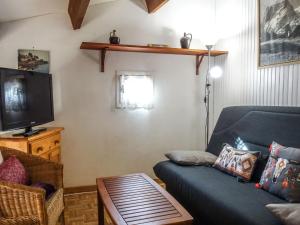 a living room with a couch and a tv at Holiday Home Les Marines des Capellans by Interhome in Saint-Cyprien-Plage