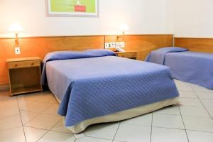 Postel nebo postele na pokoji v ubytování Jaguary Hotel Sumaré