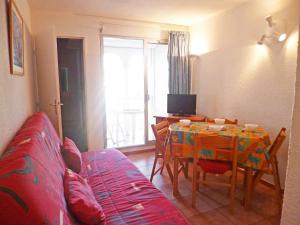 a living room with a table and a couch at Apartment Pointe Vermeille-1 by Interhome in Le Barcarès