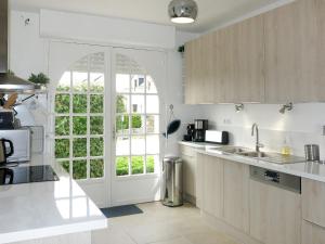 a kitchen with a window and a sink and a counter at Holiday Home Pen Er Guer - RHU362 by Interhome in Saint-Gildas-de-Rhuys